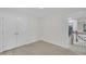 Bright bedroom with new carpet, fresh paint, and a door to the staircase at 522 N Scotswood Blvd, Hillsborough, NC 27278