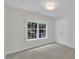 A sunlit bedroom features neutral carpet, fresh paint, and a nice window view at 522 N Scotswood Blvd, Hillsborough, NC 27278