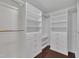 Organized closet with white shelving and drawers and dark wood floors at 522 N Scotswood Blvd, Hillsborough, NC 27278