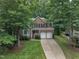 Traditional two-story brick home featuring a manicured lawn, attached two-car garage, and mature trees at 522 N Scotswood Blvd, Hillsborough, NC 27278