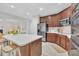 This kitchen features stainless steel appliances, white countertops and dark wood cabinetry at 522 N Scotswood Blvd, Hillsborough, NC 27278