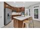 This kitchen features a central island, stainless steel appliances, and dark wood cabinetry at 522 N Scotswood Blvd, Hillsborough, NC 27278