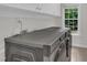 Well-equipped laundry room with modern, front-load washer and dryer under overhead cabinets and a bright window at 522 N Scotswood Blvd, Hillsborough, NC 27278