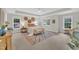 Bright main bedroom with large windows, a ceiling fan, and decorative wall art above the bed at 522 N Scotswood Blvd, Hillsborough, NC 27278