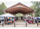 Outdoor farmer's market with vendors selling fresh produce and crafts under a large pavilion at 522 N Scotswood Blvd, Hillsborough, NC 27278
