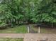 Sidewalk leading into a green wooded neighborhood at 522 N Scotswood Blvd, Hillsborough, NC 27278