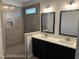 Modern bathroom featuring a tiled shower, double vanity, and stylish fixtures for a luxurious experience at 55 Leah Ln, Louisburg, NC 27549