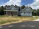 Charming two-story home featuring blue siding, a red front door and a welcoming front porch at 55 Leah Ln, Louisburg, NC 27549