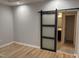 Main bedroom featuring a barn door leading to en-suite bathroom, offering a private retreat at 55 Leah Ln, Louisburg, NC 27549