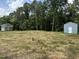 Wide open space with multiple outbuildings including one with a welcoming front porch at 55 Leah Ln, Louisburg, NC 27549