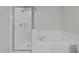 Modern bathroom featuring a glass enclosed shower and a soaking tub at 5506 Cottonrose Ln, Raleigh, NC 27606