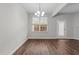 Cozy dining area features hardwood floors, a window, and a modern chandelier at 5506 Cottonrose Ln, Raleigh, NC 27606