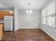 Bright dining area with natural light and a modern chandelier, adjacent to kitchen and living room at 5506 Cottonrose Ln, Raleigh, NC 27606