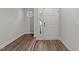 Bright entryway featuring hardwood floors and a white front door with a window for natural light at 5506 Cottonrose Ln, Raleigh, NC 27606
