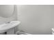 Simple half bathroom with pedestal sink and wood-look flooring, offering convenience and style at 5506 Cottonrose Ln, Raleigh, NC 27606