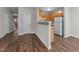Kitchen featuring white appliances, wood cabinets, and a breakfast bar overlooking an open area at 5506 Cottonrose Ln, Raleigh, NC 27606