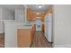 Well-lit kitchen features wooden cabinets, a white refrigerator, and stainless steel appliances at 5506 Cottonrose Ln, Raleigh, NC 27606