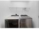 Modern laundry room with front loading washer and dryer at 5506 Cottonrose Ln, Raleigh, NC 27606