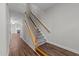 View of carpeted stairs with a wooden handrail and white trim, leading to the upper level of the home at 5506 Cottonrose Ln, Raleigh, NC 27606