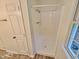 A clean bathroom features a stand-up shower, vinyl floor, and a white door at 5614 Skyline Dr, Durham, NC 27712