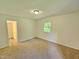 Bedroom featuring neutral walls, carpet, and a nearby doorway leading to a separate room at 5614 Skyline Dr, Durham, NC 27712