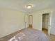 A well-lit bedroom features neutral walls and carpet, along with a closet with shelving at 5614 Skyline Dr, Durham, NC 27712