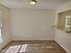 Bright dining room featuring wood-look flooring and natural light from the window at 5614 Skyline Dr, Durham, NC 27712