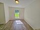 Open-concept dining room with wood-look flooring and a view of the backyard at 5614 Skyline Dr, Durham, NC 27712