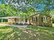 Charming brick home featuring a covered porch and lush green lawn at 5614 Skyline Dr, Durham, NC 27712