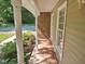 Inviting front porch with brick flooring and classic white columns at 5614 Skyline Dr, Durham, NC 27712