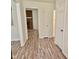 Hallway with wood look floors leads to rooms and bathrooms at 5614 Skyline Dr, Durham, NC 27712