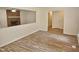 Spacious living room with a cozy brick fireplace and modern flooring at 5614 Skyline Dr, Durham, NC 27712