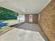 Covered patio with brick detailing, offering a cozy outdoor space at 5614 Skyline Dr, Durham, NC 27712