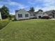 Charming single-story home with a well-manicured lawn and black shutters against a light gray exterior at 5810 Stardust Ct, Durham, NC 27712