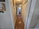 Clean hallway featuring wood floors and a view to the bathroom at 5810 Stardust Ct, Durham, NC 27712