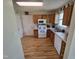 Functional kitchen with white appliances, wood cabinets and flooring at 5810 Stardust Ct, Durham, NC 27712