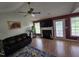 Cozy living room with a fireplace, ceiling fan, and hardwood floors at 5810 Stardust Ct, Durham, NC 27712