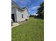 Spacious side yard featuring a well-maintained lawn and view of the house siding at 5810 Stardust Ct, Durham, NC 27712