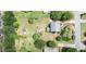 A top-down aerial view of the home shows the backyard with sheds and trees at 601 Country Ln, Holly Springs, NC 27540