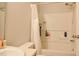 Clean bathroom featuring a shower-tub combo and storage shelves at 601 Country Ln, Holly Springs, NC 27540
