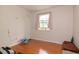 Bedroom featuring wood floors, natural light from a window, and neutral wall color at 601 Country Ln, Holly Springs, NC 27540