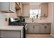Well-lit kitchen features modern appliances, stylish cabinets, and a window with a view at 601 Country Ln, Holly Springs, NC 27540
