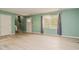 Inviting living room featuring natural light, light green walls, and modern flooring at 601 Country Ln, Holly Springs, NC 27540