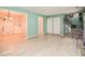 Open living area with laminate flooring, view to dining room and decorative staircase at 601 Country Ln, Holly Springs, NC 27540