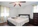 Spacious bedroom featuring a modern bed frame, a ceiling fan, and natural light at 601 Country Ln, Holly Springs, NC 27540