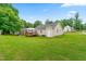 Home exterior featuring an expansive green yard, deck and partial gazebo at 601 Southampton Dr, Knightdale, NC 27545