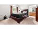 Spacious bedroom with a large bed, neutral carpet, and access to the bathroom at 601 Southampton Dr, Knightdale, NC 27545
