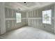 Bright bedroom with two windows and drywall waiting for finishing touches at 6505 Burnette Flower Way, Raleigh, NC 27612