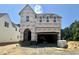 Exterior view of home under construction with visible windows, garage, and building materials at 6505 Burnette Flower Way, Raleigh, NC 27612