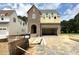 New two-story home with brick and siding, featuring an attached garage and unfinished landscaping at 6505 Burnette Flower Way, Raleigh, NC 27612